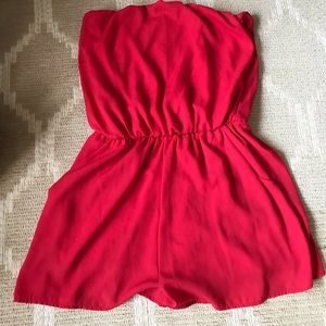 Red shorts strapless romper with pockets.